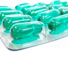 Blister opakowania z zielonymi kapsułkami. Pamiętaj o prawidłowym ibuprofen dawkowanie, by skutecznie złagodzić ból.